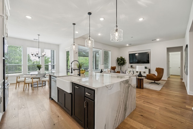 307 Misty Ln, Argyle, TX 76226 - kitchen with a chandelier, light wood-type flooring, recessed lighting, light stone counters, and open floor plan