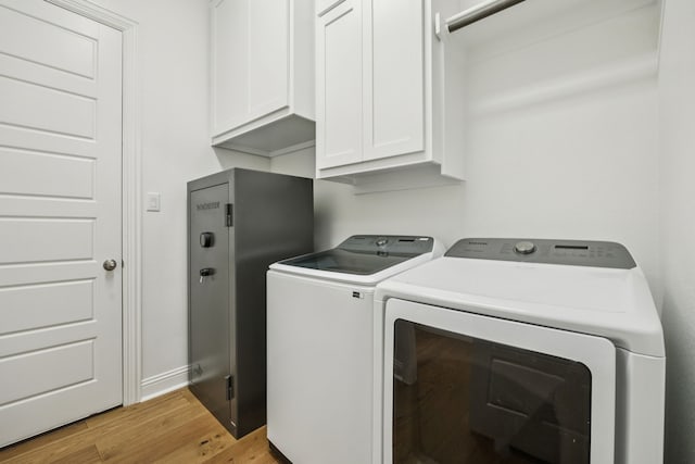 307 Misty Ln, Argyle, TX 76226 - laundry room with washer and dryer, cabinet space, and light wood finished floors