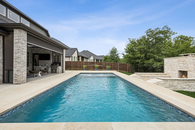 307 Misty Ln, Argyle, TX 76226 - view of pool featuring an outdoor stone fireplace, a patio area, area for grilling, and a fenced backyard