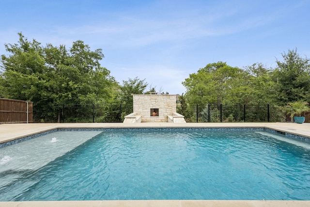 307 Misty Ln, Argyle, TX 76226 - view of pool with an outdoor stone fireplace and a patio area