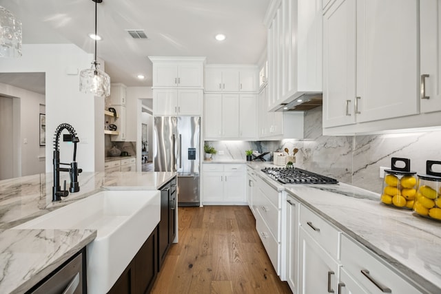 307 Misty Ln, Argyle, TX 76226 - kitchen featuring appliances with stainless steel finishes, custom exhaust hood, white cabinets, recessed lighting, and hanging light fixtures