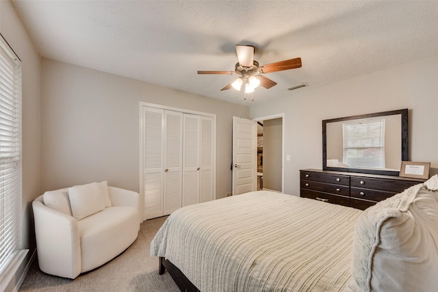 640 Silverstone Dr, Richardson, TX 75080 - bedroom with a closet, light carpet, multiple windows, and a ceiling fan