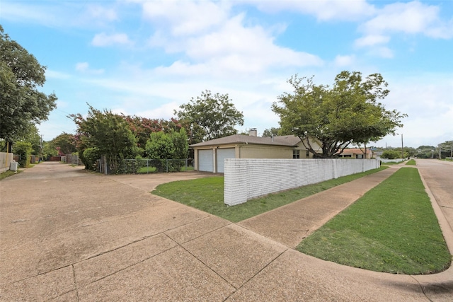 640 Silverstone Dr, Richardson, TX 75080 - view of home's exterior with a garage, concrete driveway, and a chimney
