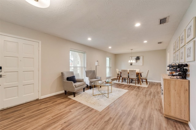 640 Silverstone Dr, Richardson, TX 75080 - living area featuring light wood-type flooring, recessed lighting, and a chandelier