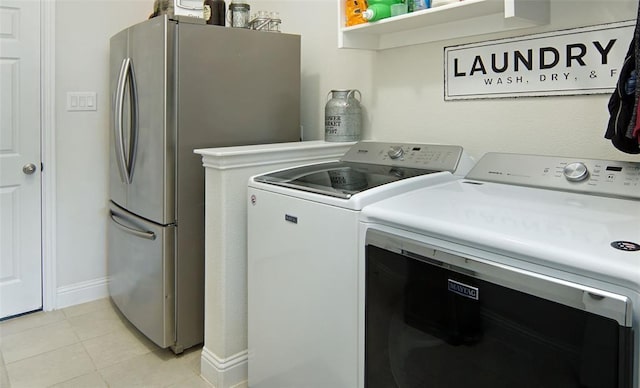 219 Spruce Valley Dr, Justin, TX 76247 - laundry area featuring washing machine and dryer and light tile patterned flooring