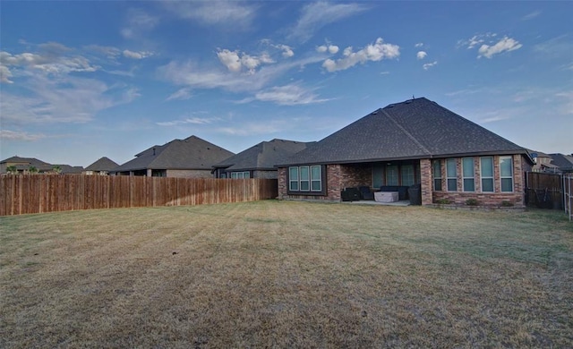 219 Spruce Valley Dr, Justin, TX 76247 - back of house with a fenced backyard, brick siding, and a patio