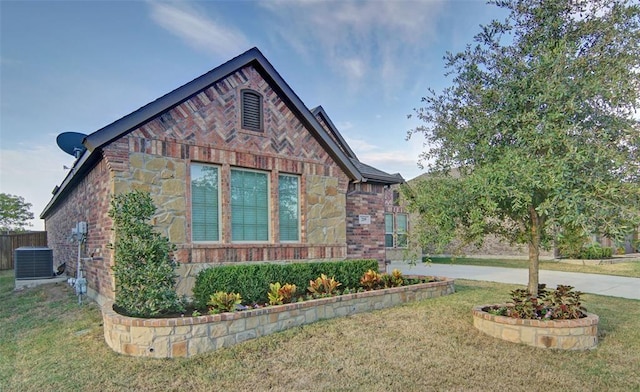 219 Spruce Valley Dr, Justin, TX 76247 - view of side of home featuring stone siding, a yard, and brick siding