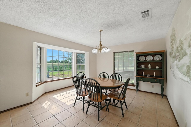 7220 Tucker Dr, Weatherford, TX 76085 - dining space featuring a chandelier, light tile patterned floors, and a textured ceiling