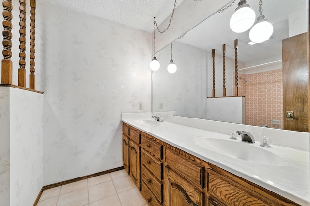 7220 Tucker Dr, Weatherford, TX 76085 - bathroom featuring double vanity, tile patterned flooring, a shower, and a textured ceiling
