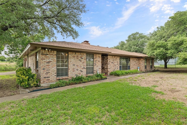 7220 Tucker Dr, Weatherford, TX 76085 - ranch-style home featuring a front yard, brick siding, and a chimney