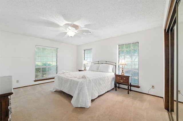 7220 Tucker Dr, Weatherford, TX 76085 - bedroom with light carpet, a textured ceiling, and a ceiling fan