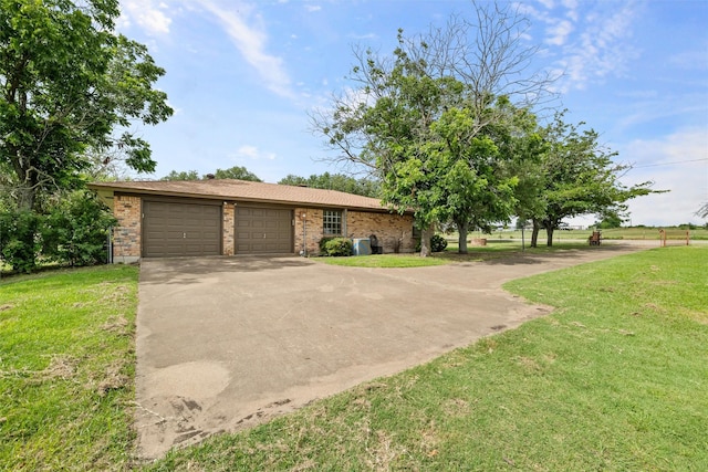 7220 Tucker Dr, Weatherford, TX 76085 - view of front of property featuring driveway, an attached garage, a front lawn, and brick siding