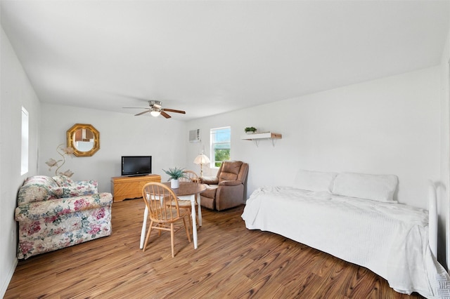 7220 Tucker Dr, Weatherford, TX 76085 - bedroom with light wood-type flooring, ceiling fan, and a wall unit AC