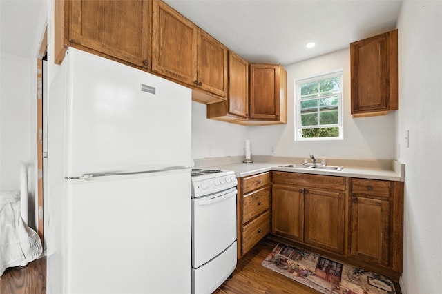 7220 Tucker Dr, Weatherford, TX 76085 - kitchen featuring white appliances, wood finished floors, light countertops, brown cabinetry, and recessed lighting