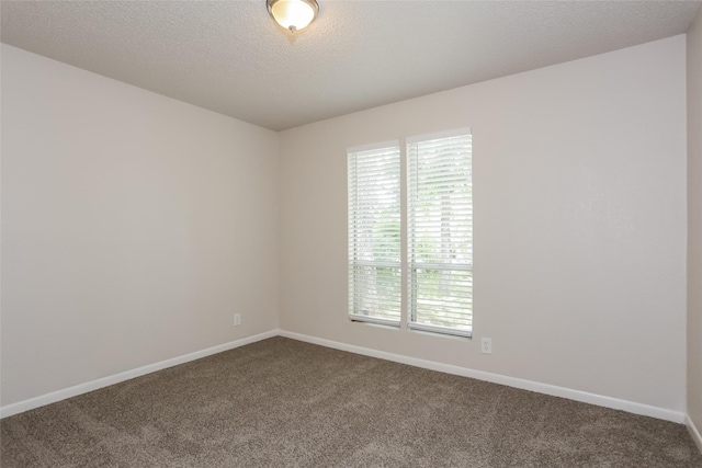 1209 Pin Oak Dr, Denton, TX 76209 - unfurnished room featuring dark colored carpet and a textured ceiling