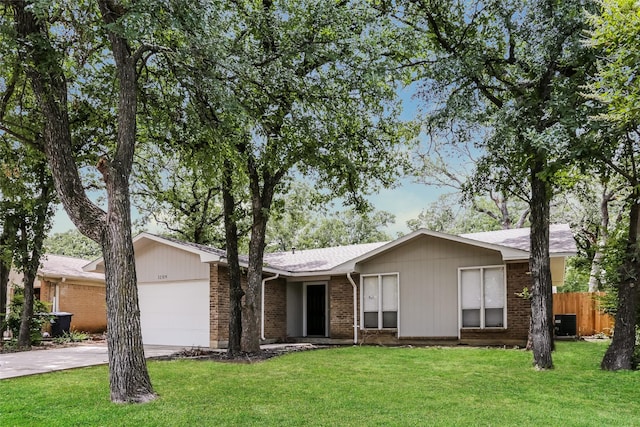 1209 Pin Oak Dr, Denton, TX 76209 - view of front of house with an attached garage, brick siding, and driveway