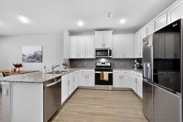 1848 Indigo Ln, Forney, TX 75126 - kitchen featuring stainless steel appliances, a peninsula, white cabinets, and recessed lighting