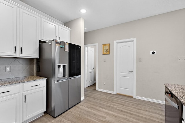 1848 Indigo Ln, Forney, TX 75126 - kitchen with stainless steel appliances, light wood-style flooring, decorative backsplash, white cabinetry, and light stone counters