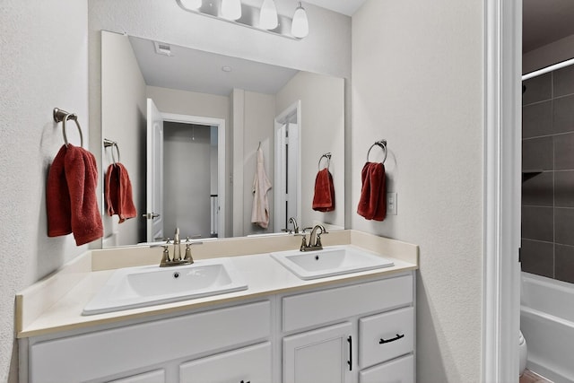 1848 Indigo Ln, Forney, TX 75126 - full bathroom featuring double vanity, shower / bathtub combination, and a textured wall