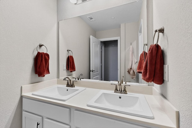 1848 Indigo Ln, Forney, TX 75126 - bathroom featuring double vanity and a textured wall