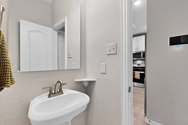 1848 Indigo Ln, Forney, TX 75126 - bathroom featuring wood finished floors and a textured wall