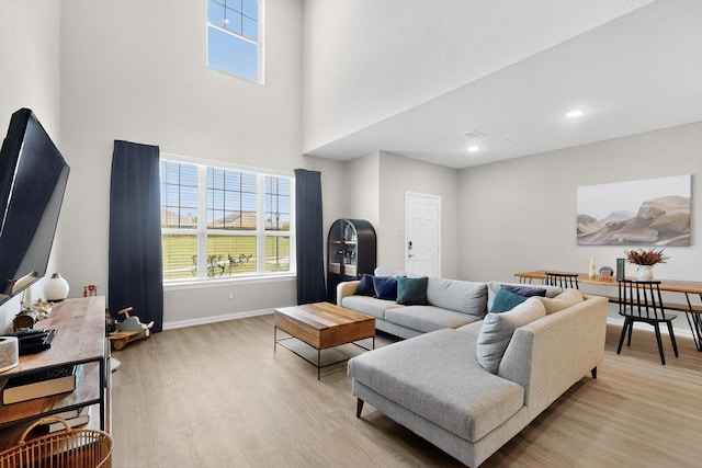 1848 Indigo Ln, Forney, TX 75126 - living area featuring light wood finished floors, plenty of natural light, a towering ceiling, and recessed lighting