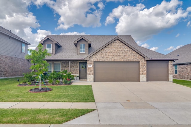 276 Jefferson Ln, Fate, TX 75189 - view of front of house featuring brick siding, a garage, a front lawn, and a shingled roof