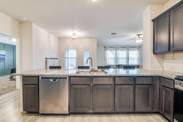 276 Jefferson Ln, Fate, TX 75189 - kitchen with stainless steel dishwasher, ceiling fan, dark brown cabinetry, and plenty of natural light