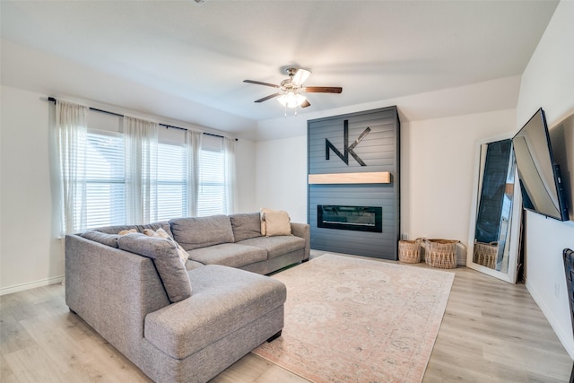276 Jefferson Ln, Fate, TX 75189 - living area featuring a ceiling fan, light wood-style flooring, and a large fireplace