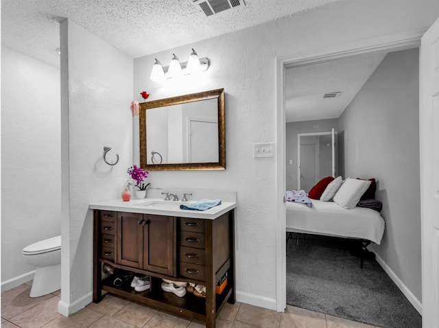 1013 Huntersglen Dr, Mesquite, TX 75150 - bathroom with vanity, a textured ceiling, ensuite bath, and tile patterned flooring