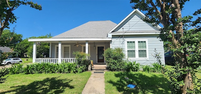 108 S Bonham St, Mexia, TX 76667 - bungalow-style house featuring covered porch, a front yard, a ceiling fan, and roof with shingles
