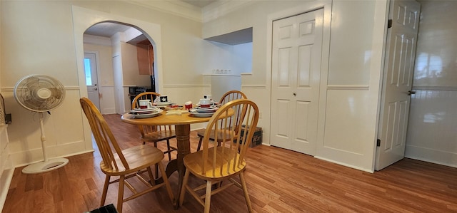 108 S Bonham St, Mexia, TX 76667 - dining area with arched walkways, light wood-style floors, and ornamental molding