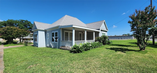 108 S Bonham St, Mexia, TX 76667 - view of side of property with a porch, a lawn, and roof with shingles