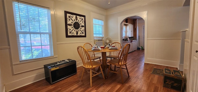 108 S Bonham St, Mexia, TX 76667 - dining area with arched walkways, crown molding, wood finished floors, wainscoting, and cooling unit