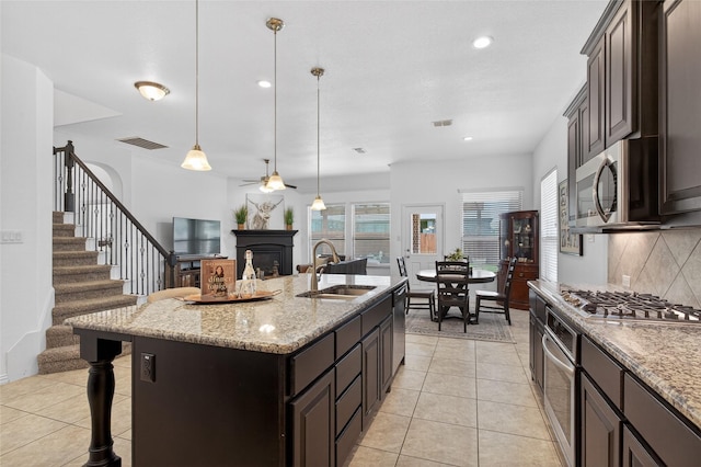 14800 Star Creek Dr, Aledo, TX 76008 - kitchen with appliances with stainless steel finishes, decorative backsplash, ceiling fan, light tile patterned floors, and recessed lighting