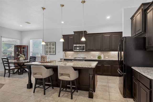 14800 Star Creek Dr, Aledo, TX 76008 - kitchen featuring stainless steel microwave, freestanding refrigerator, tasteful backsplash, light tile patterned floors, and recessed lighting