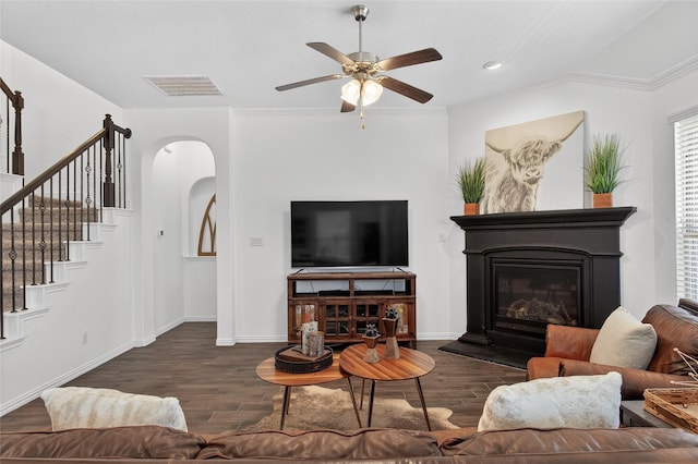 14800 Star Creek Dr, Aledo, TX 76008 - living room featuring wood finished floors, arched walkways, stairway, a glass covered fireplace, and ceiling fan