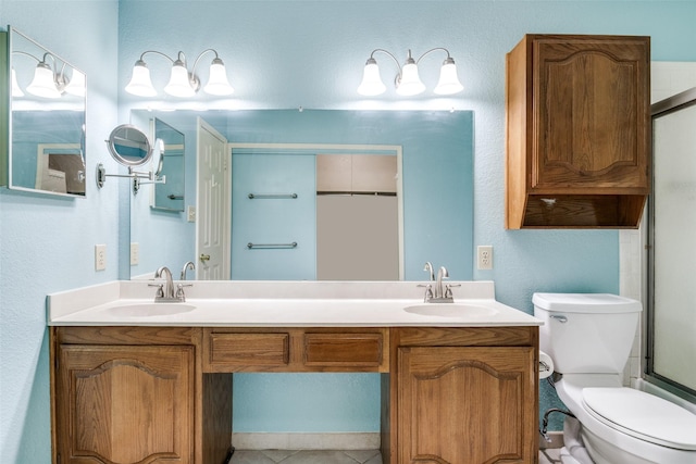 1524 Regent St, Mesquite, TX 75149 - full bathroom featuring a shower with door, double vanity, and a textured wall