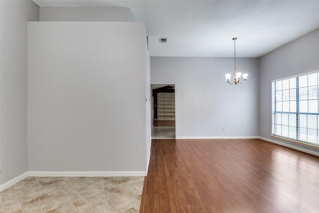 1524 Regent St, Mesquite, TX 75149 - empty room featuring a chandelier and light wood-style flooring