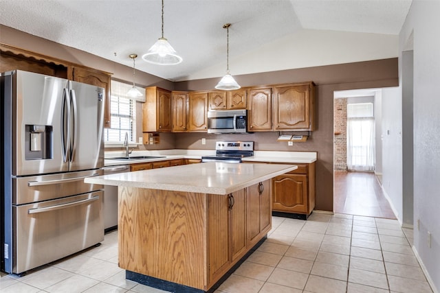 1524 Regent St, Mesquite, TX 75149 - kitchen featuring stainless steel appliances, light countertops, lofted ceiling, light tile patterned floors, and a center island