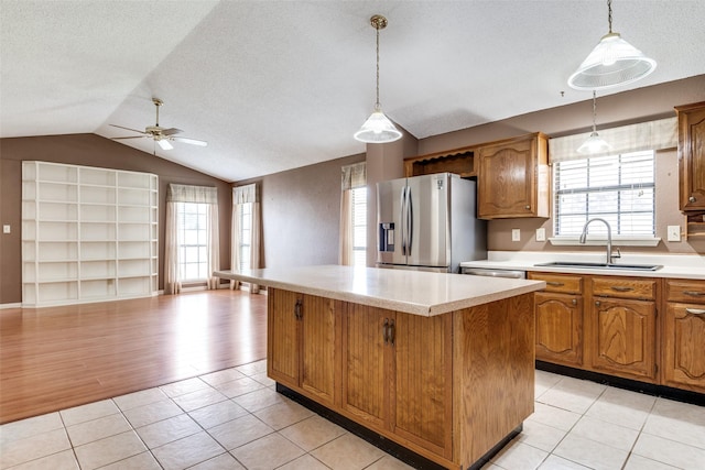 1524 Regent St, Mesquite, TX 75149 - kitchen featuring stainless steel fridge, a ceiling fan, a kitchen island, light countertops, and lofted ceiling