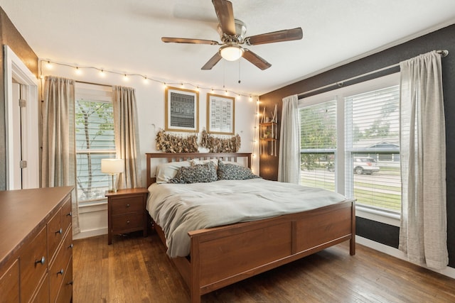 5029 Jerri Ln, Haltom City, TX 76117 - bedroom featuring dark wood-style floors, multiple windows, and ceiling fan