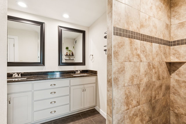 5029 Jerri Ln, Haltom City, TX 76117 - bathroom featuring double vanity, tile patterned flooring, tiled shower, and recessed lighting