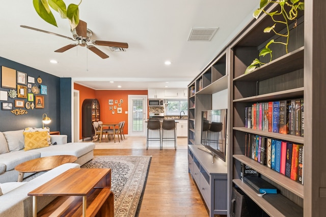 5029 Jerri Ln, Haltom City, TX 76117 - living area with light wood finished floors, ceiling fan, and recessed lighting