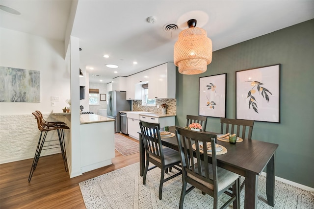 714 Silverstone Dr, Richardson, TX 75080 - dining area with light wood-style flooring and recessed lighting