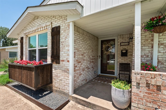 714 Silverstone Dr, Richardson, TX 75080 - entrance to property with brick siding, board and batten siding, and covered porch