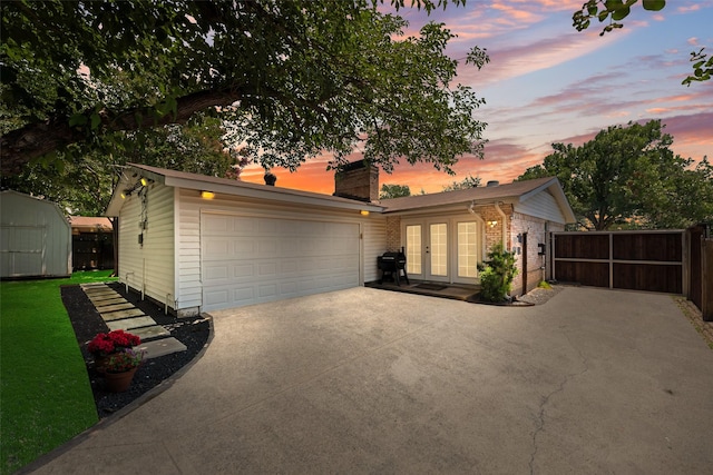 714 Silverstone Dr, Richardson, TX 75080 - view of front of property with french doors, a chimney, concrete driveway, a garage, and brick siding