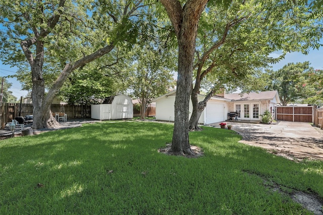 714 Silverstone Dr, Richardson, TX 75080 - fenced backyard featuring french doors, a storage shed, a garage, and a patio