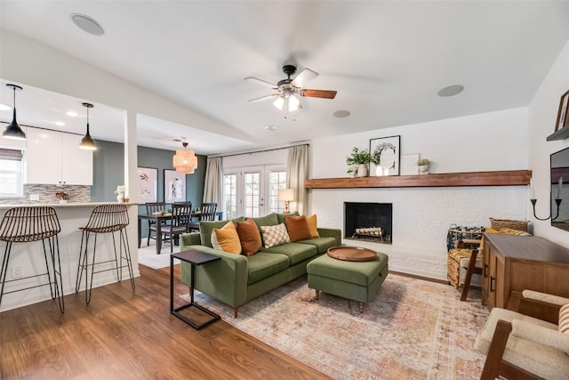 714 Silverstone Dr, Richardson, TX 75080 - living room with a fireplace, ceiling fan, wood finished floors, and plenty of natural light