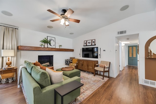 714 Silverstone Dr, Richardson, TX 75080 - living room featuring ceiling fan, vaulted ceiling, wood finished floors, and arched walkways